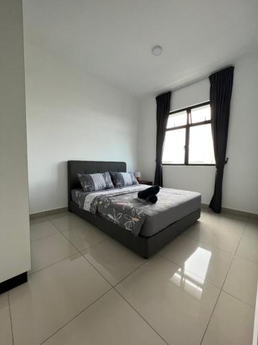 a bedroom with a bed and a window at Desaru Utama Residance Aisy Homestay in Kota Tinggi
