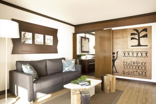 a living room with a couch and a table at Le Tahiti by Pearl Resorts in Papeete
