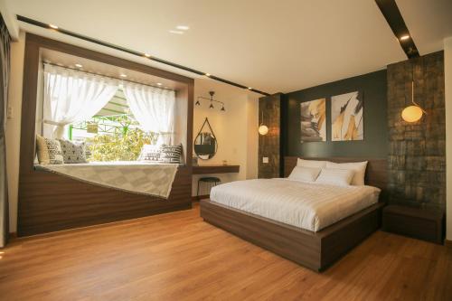 a bedroom with a large bed and a window at Fati Boutique Hotel & Apartment in Vung Tau