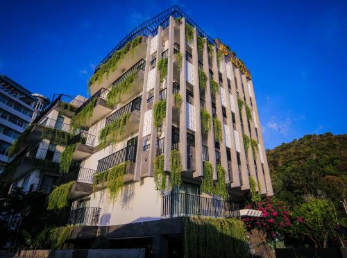 a building with plants on the side of it at Fati Boutique Hotel & Apartment in Vung Tau