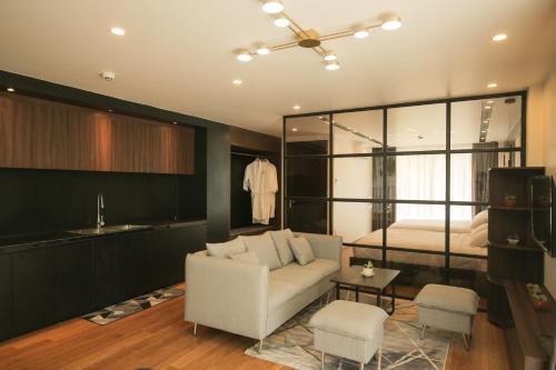a living room with a couch and a bed at Fati Boutique Hotel & Apartment in Vung Tau
