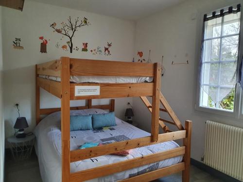 a bedroom with two bunk beds in a room at Gite LOCMOUSTERU in Moustéru