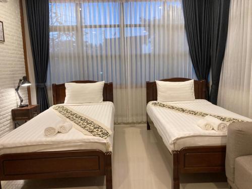 Postel nebo postele na pokoji v ubytování Baan Suanfah Kiangdao