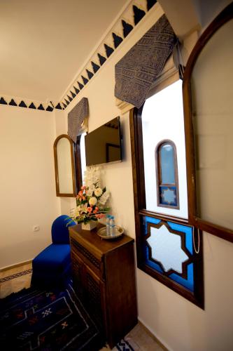 a room with a mirror and a table and a chair at Dar Yasmine in Tangier