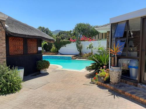 a house with a swimming pool in a yard at Vergenoegd Guesthouse in Panorama