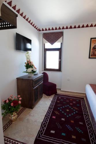 a living room with a couch and a tv at Dar Yasmine in Tangier