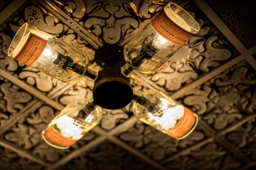 a chandelier with four glass bottles on a ceiling at Holiday Inn St. Paul Downtown by IHG in Saint Paul