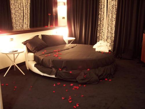a bedroom with a bed with red flowers on the floor at Grand Hotel Paradiso in Catanzaro Lido
