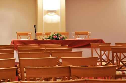 a room with a table and chairs with a flower on it at Paliria Hotel in Chalkida