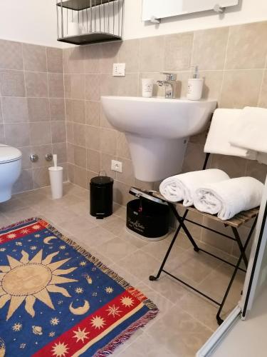 a bathroom with a sink and a toilet and a rug at Ferrari Formula 1 in Orio al Serio