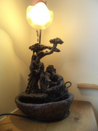 a rock bowl with a bonsai lamp on a table at Monastery View in Bunacurry