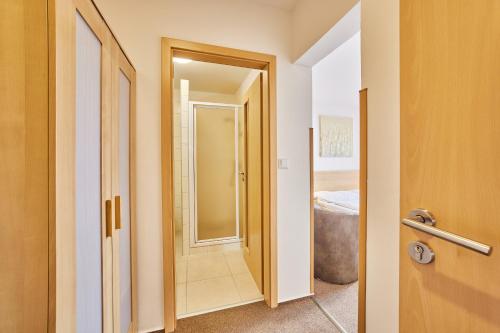 a hallway with a door leading to a bathroom at Pension Valja in Janske Lazne