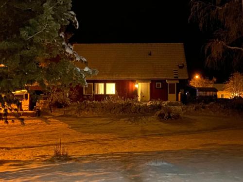 a house at night with the lights on at Villa Stolle in Hammarstrand
