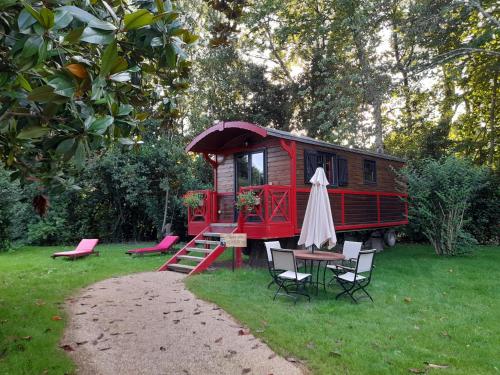 a red tiny house with a table and chairs at Hôtel Quai des Pontis in Cognac