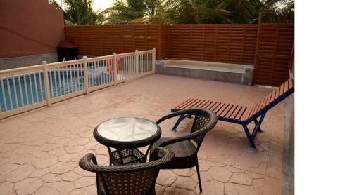 a patio with a table and chairs and a bench at Hotel & Resort Golden Marina Yanbu in Yanbu