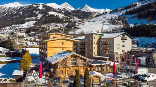 a town in the snow with mountains in the background at AlpenParks Hotel MONTANA in Matrei in Osttirol
