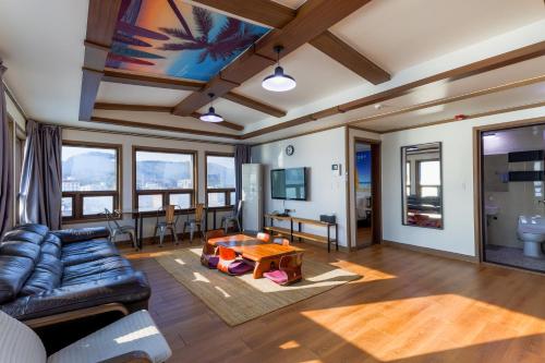 a living room with a couch and a table at Residence Hotel Blue Ocean View in Ulsan