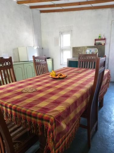 a table with a plate of bananas on top of it at Villa Sunrise in Induruwa