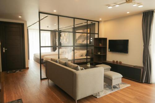 a living room with a couch and a bed at Fati Boutique Hotel & Apartment in Vung Tau