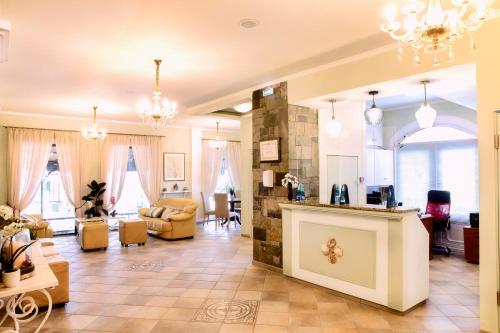 a living room with a couch and a table at Molfetta Beach Hotel  in Gouvia