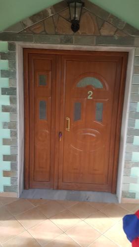 a wooden door with a number on it at Villa RELAX in Nea Vrasna