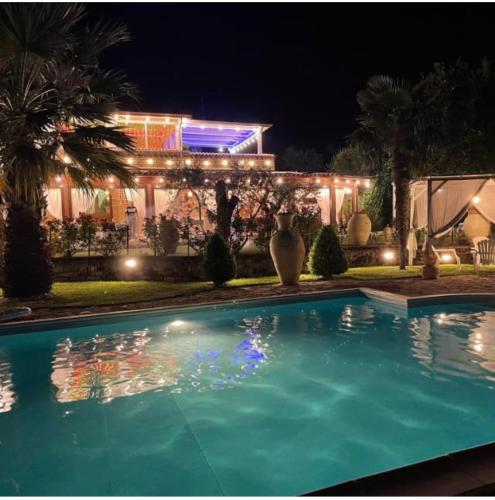 a swimming pool in front of a building at night at VILLA "Casa al Chiazzullo" in Mirabella Eclano