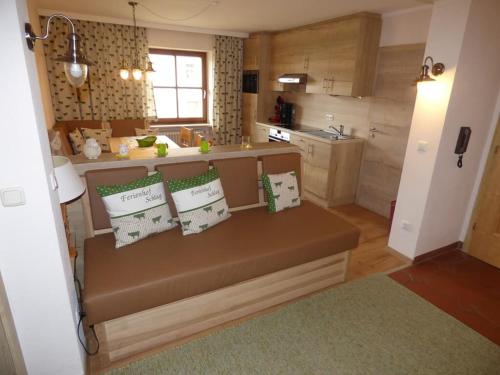 a kitchen with a bench with pillows on it at Ferienhof Schlag in Waldmünchen