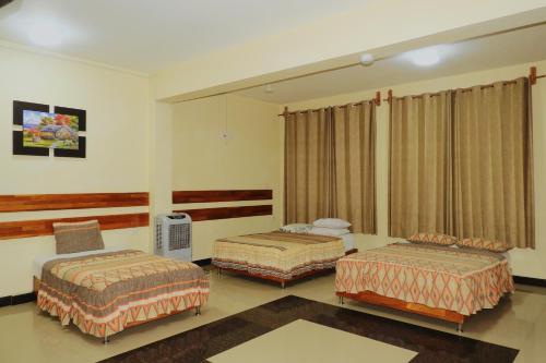a room with two beds in a room at Casa Nativa Iquitos in Iquitos