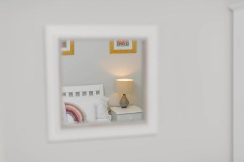 a picture of a bedroom with a bed and a lamp at Corffe House and Holiday Cottages in Barnstaple