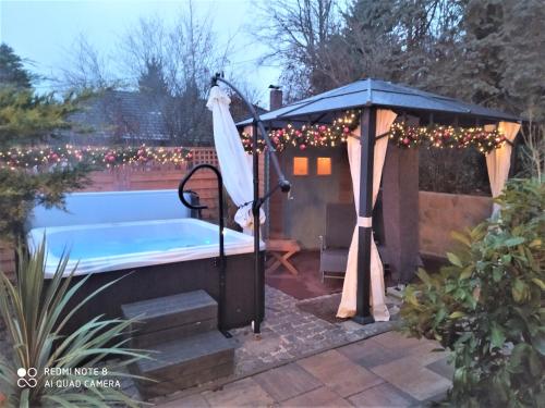 a hot tub in a gazebo with christmas lights at Mediterran-Skandinavisch - Outdoorwhirlpool ganzjährig in Burgthann