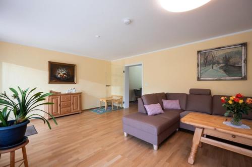 a living room with a couch and a table at Ferienwohnung Wertenauer in Kiefersfelden