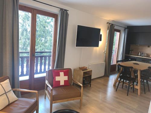 a living room with a couch and a table at La Résidence de L'Ours in Megève
