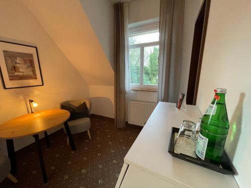 a room with a green bottle on a counter at dS Hotel Gronau in Gronau