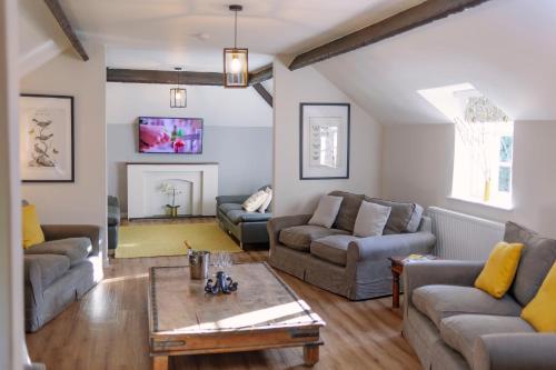 a living room with two couches and a table at Corffe House and Holiday Cottages in Barnstaple