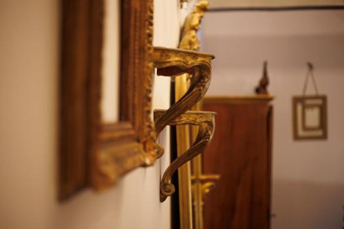 an ornate gold mirror on a wall next to a cabinet at Conacul Archia in Deva