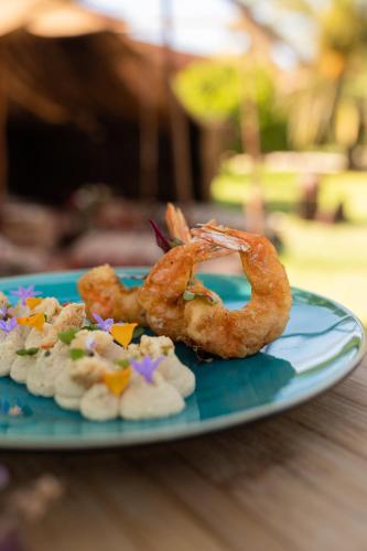 a plate of shrimp and other food on a table at Domaine Des Remparts Hotel & Spa in Marrakech