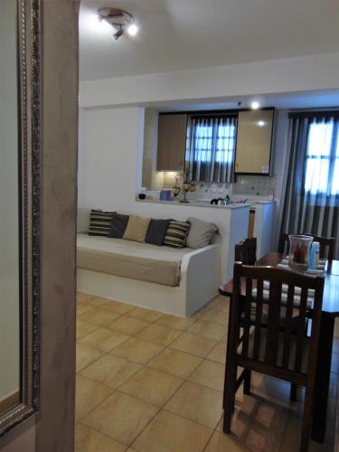 a living room with a couch and a kitchen at Lefteris Houses in Karterados