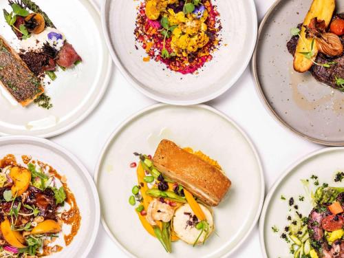 a group of plates of food on a table at Sydney Central Hotel managed by The Ascott Limited in Sydney