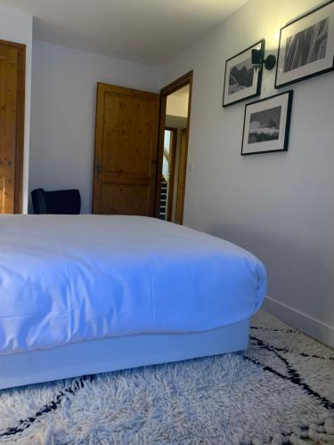 a bedroom with a bed with a blue comforter at La Résidence de L'Ours in Megève