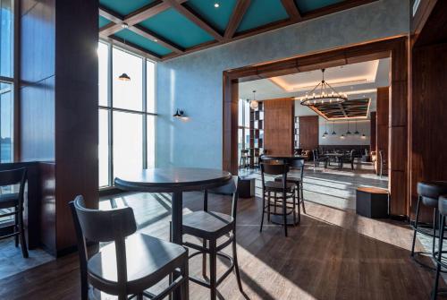 a dining room with a table and some chairs at Radisson Resort Ras Al Khaimah Marjan Island in Ras al Khaimah