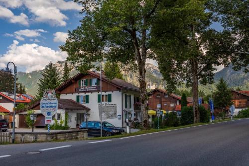 a building on the side of a road in a town at Hotel Pension Schwansee in Schwangau
