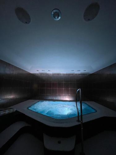 a large blue tub in a room with a ceiling at Pension Slunečnice & Panorama Restaurace Farma in Špindlerův Mlýn