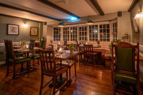 a restaurant with tables and chairs in a room at Castle Inn in West Lulworth