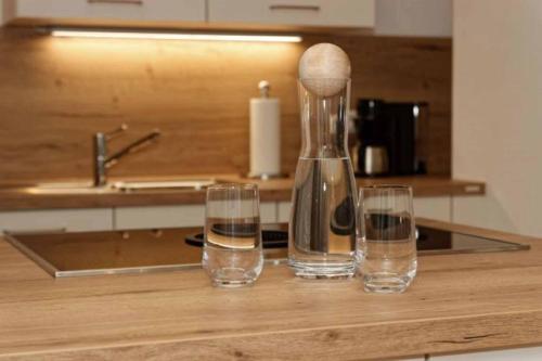 a kitchen counter with two glasses and a blender at Ferienwohnung Lankl im Bayerischen Wald in Röhrnbach
