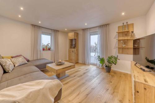 a living room with a couch and a table at Ferienwohnung Lankl im Bayerischen Wald in Röhrnbach