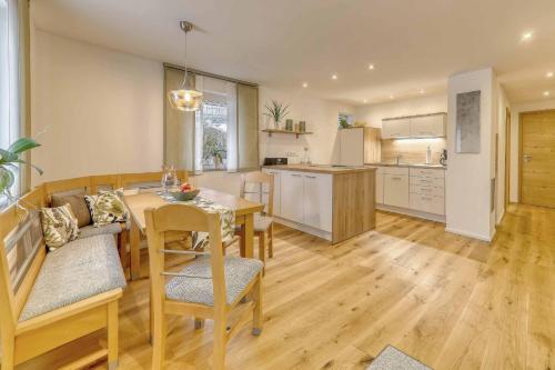 a kitchen and dining room with a table and chairs at Ferienwohnung Lankl im Bayerischen Wald in Röhrnbach