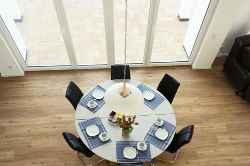 a dining room with a table and black chairs at Villa Silbermöwe in Trent