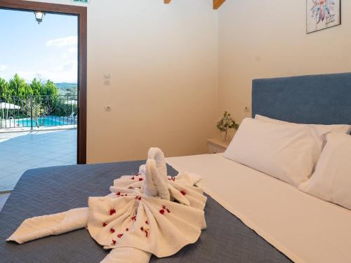 a bedroom with a bed with towels on it at Villa Lucas in Melidhónion