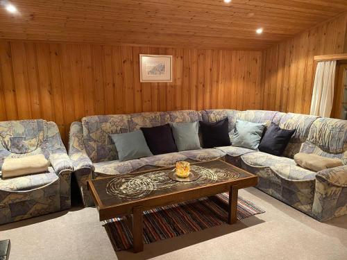 a living room with a couch and a coffee table at Tgesa Frena in Sedrun