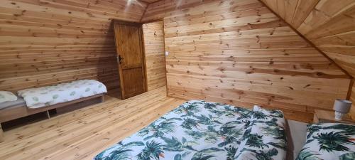 a room with two beds in a wooden cabin at Domek Letniskowy, Dom Całoroczny Eryś 80m2. Przy Plaży. Wynajem. Odpoczynek in Książki